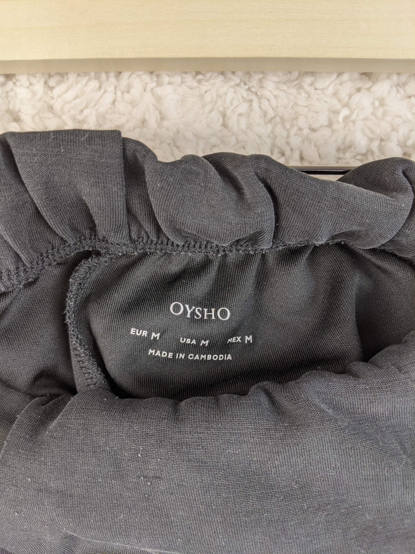 Close-up of Oysho label on gray shorts