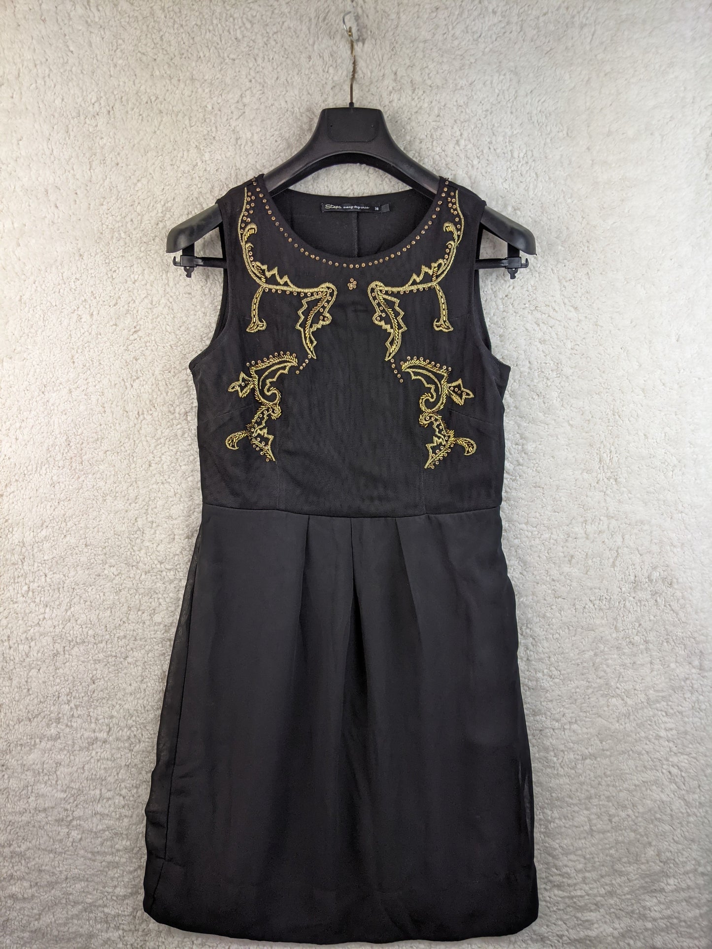 Front view of black embellished dress