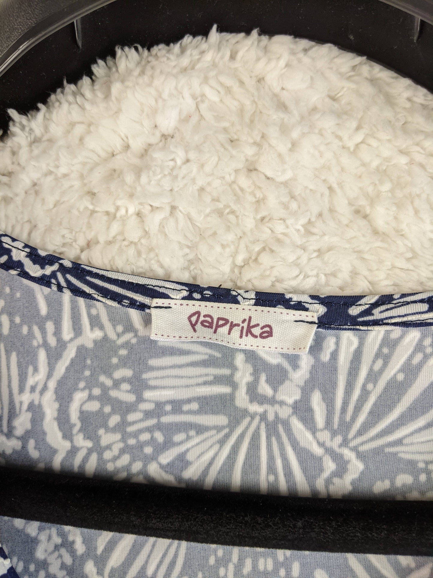 Brand label on navy and white floral dress
