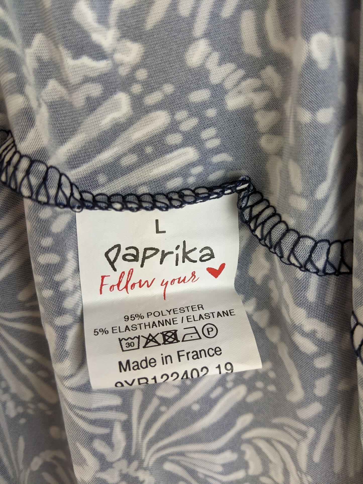 Size and material label of navy and white floral dress