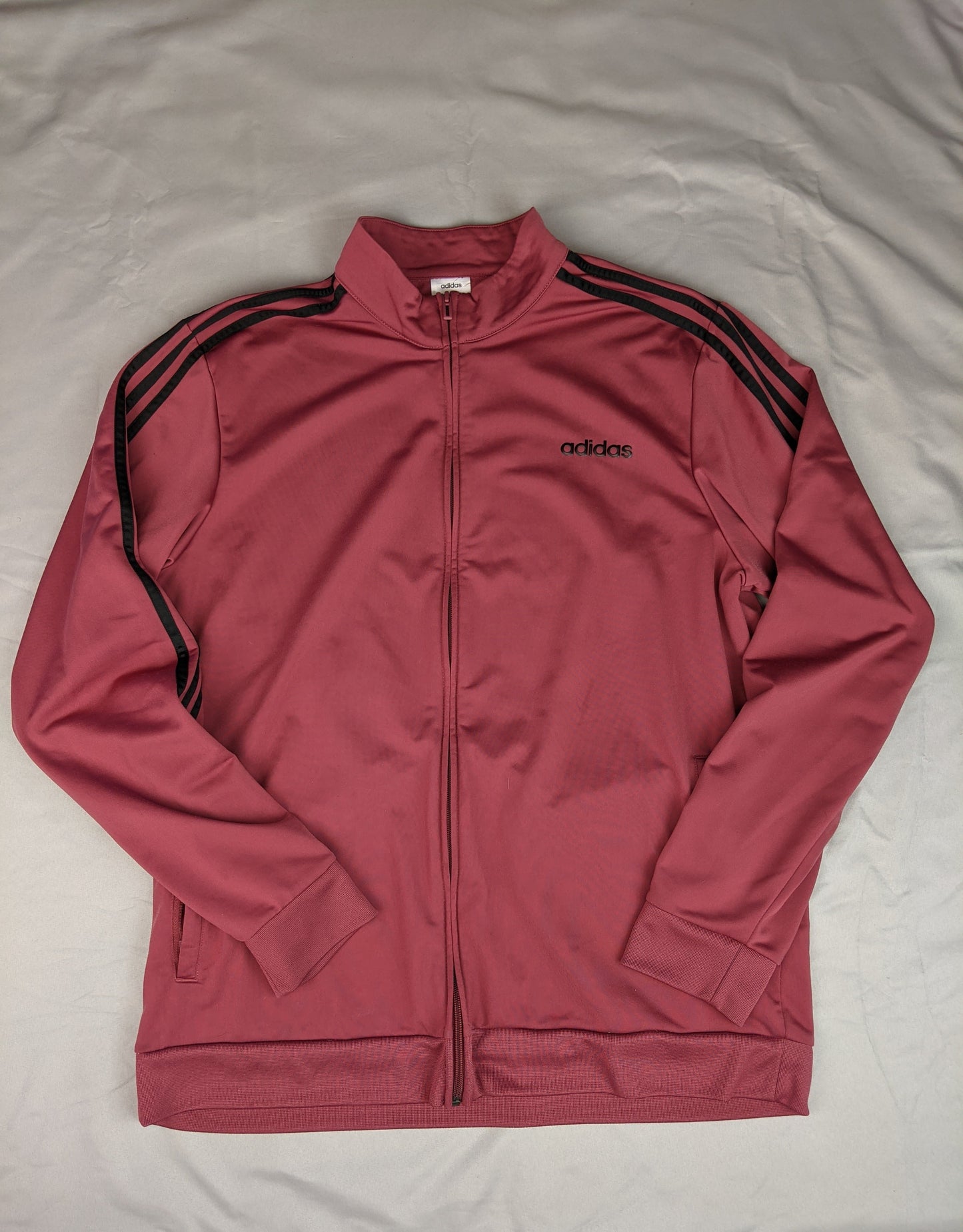 Front view of maroon Adidas track jacket