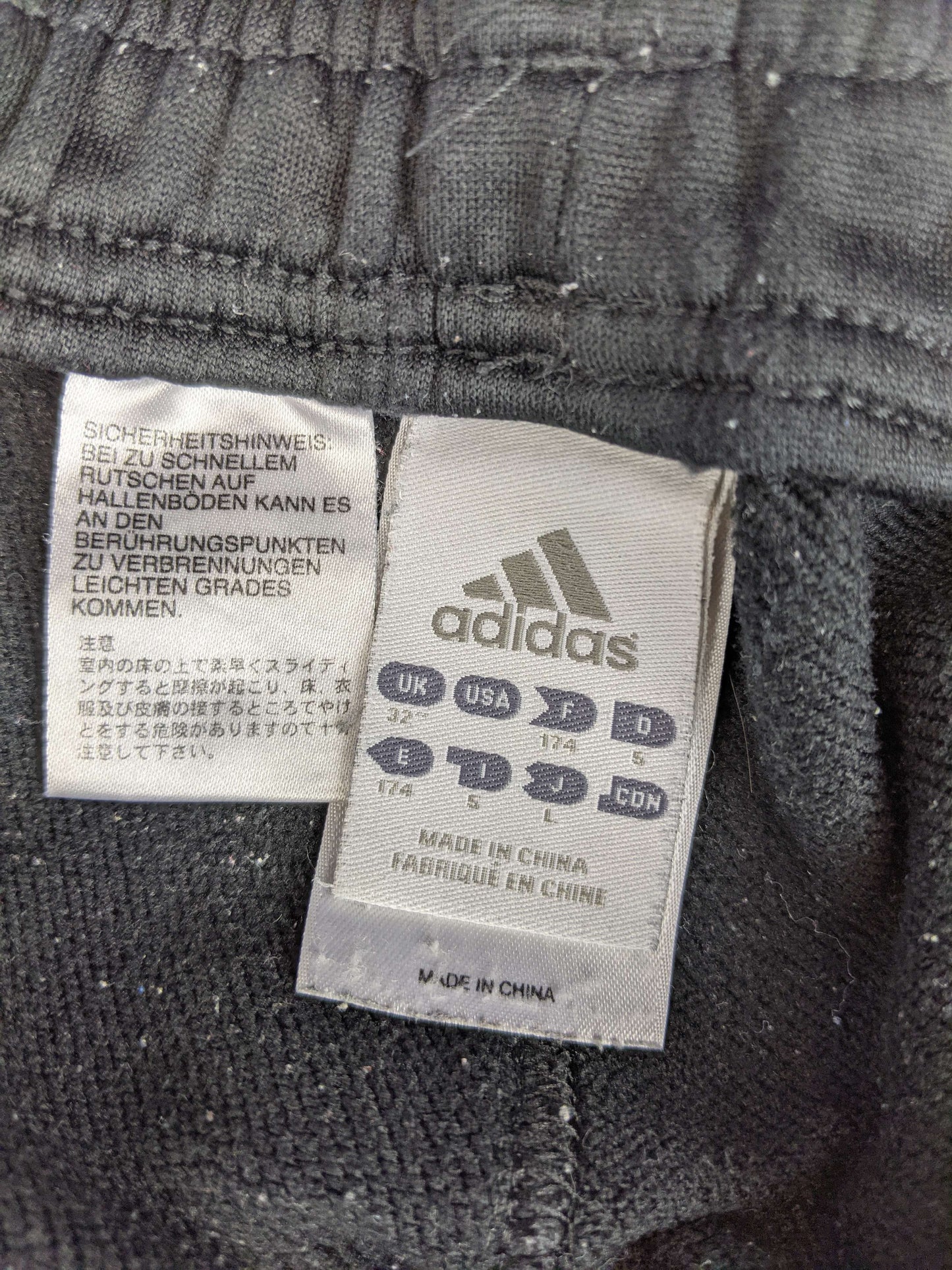 Size label of Adidas AC Milan black training shorts