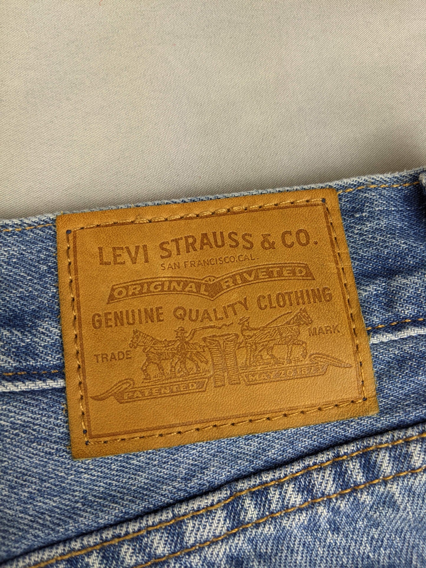 Close-up of Levi's logo patch on denim skirt