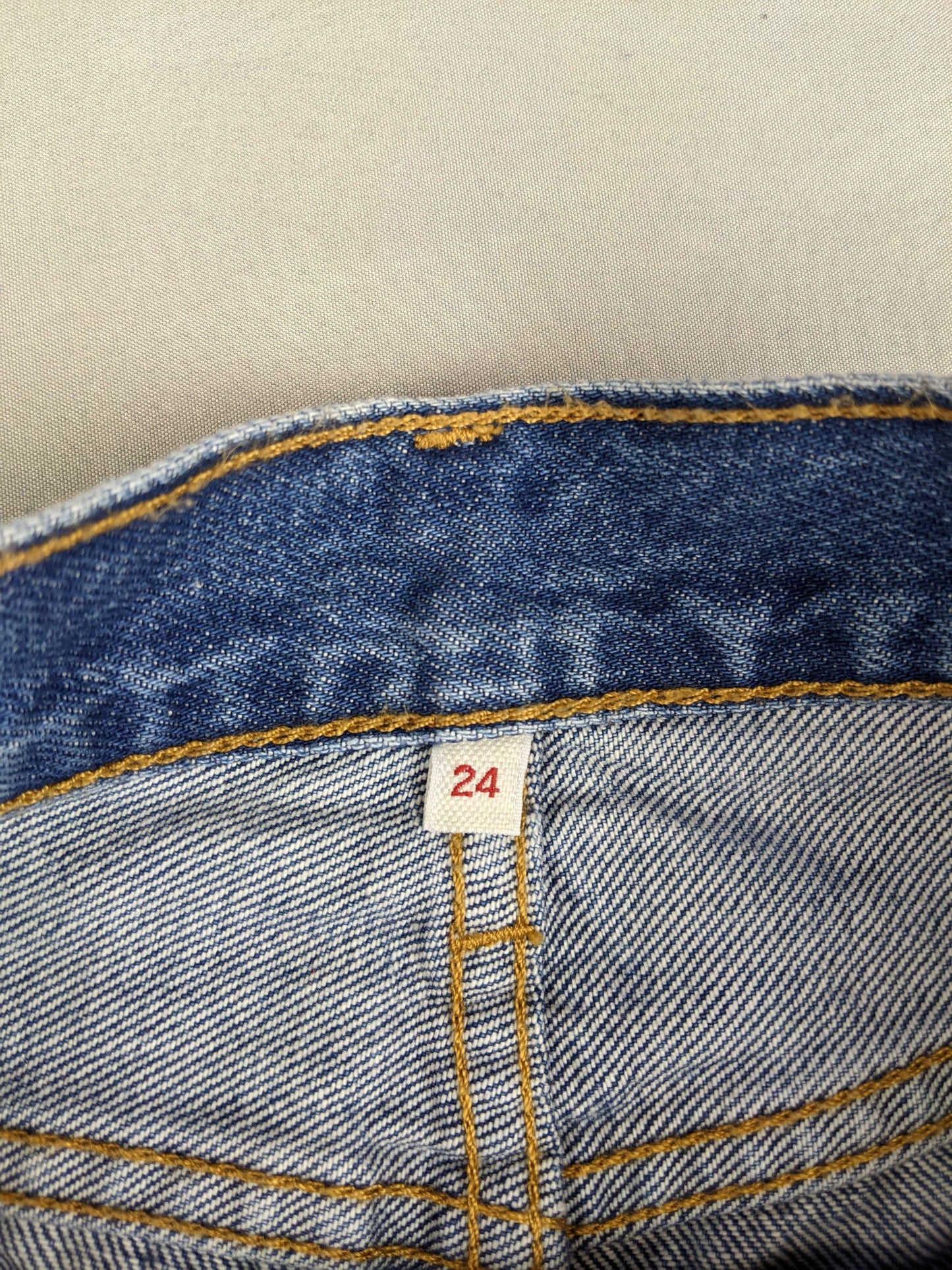 Close-up of size label on denim skirt
