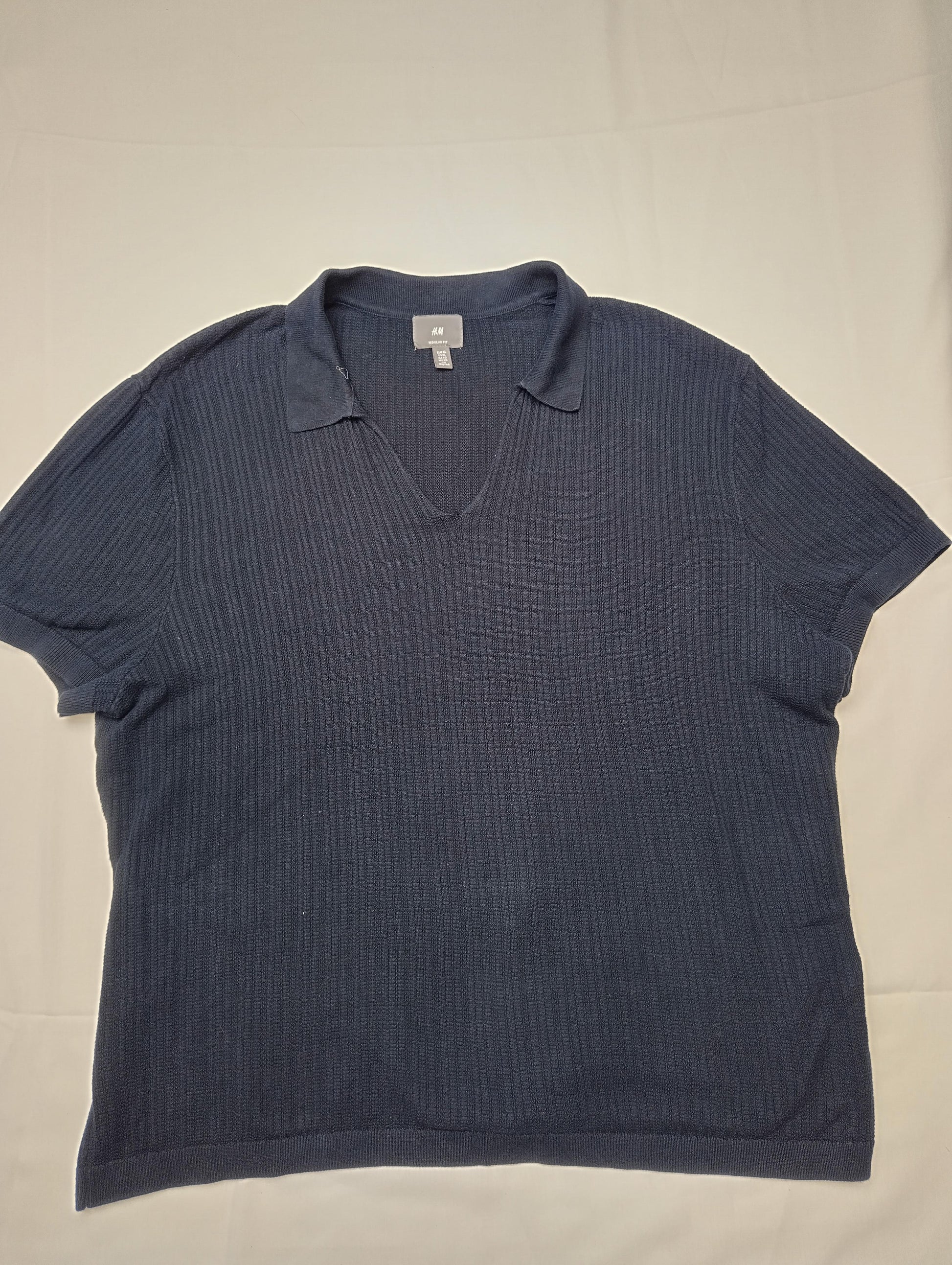 Front view of H&M navy polo shirt