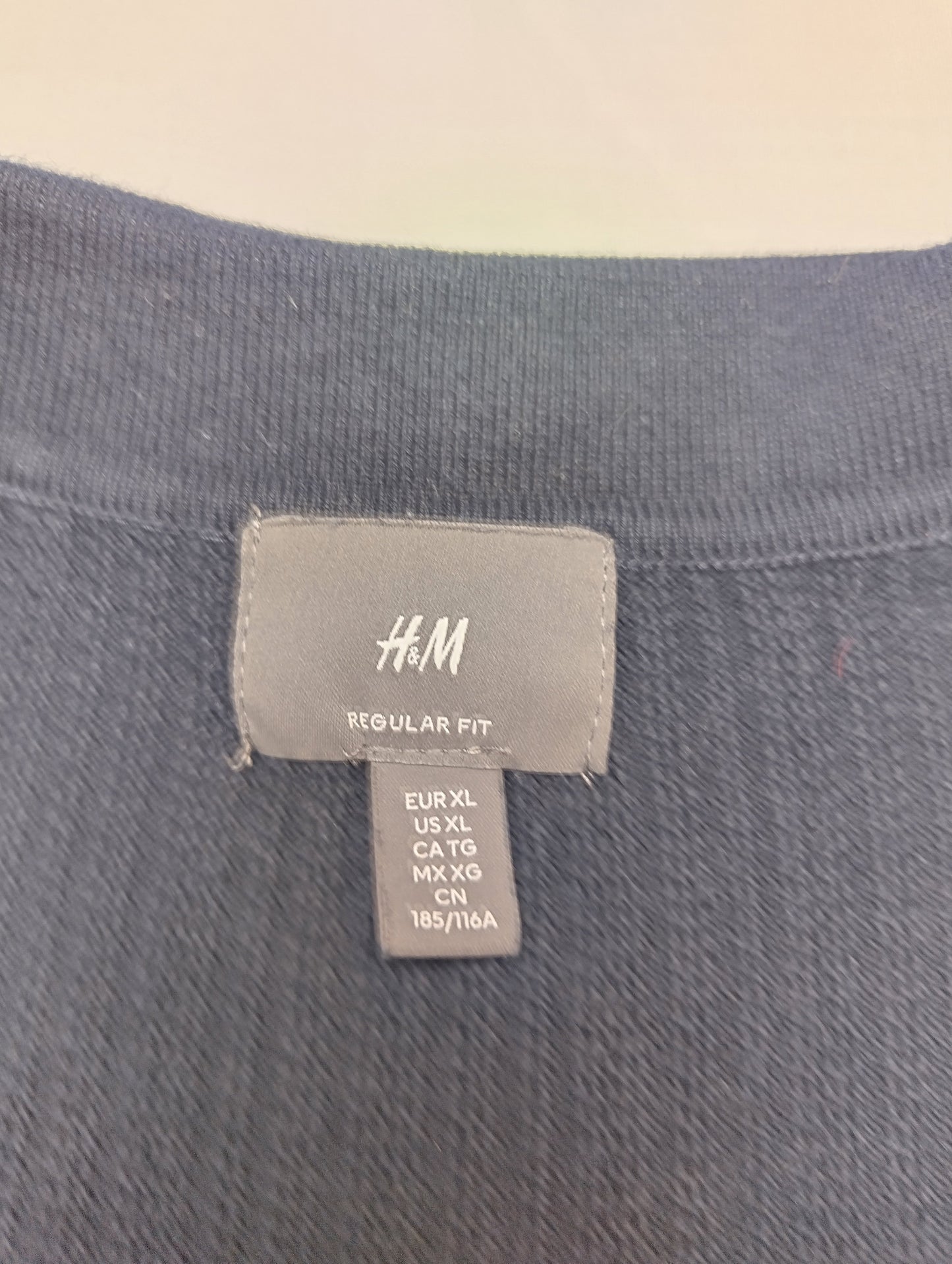 Label of H&M navy polo shirt
