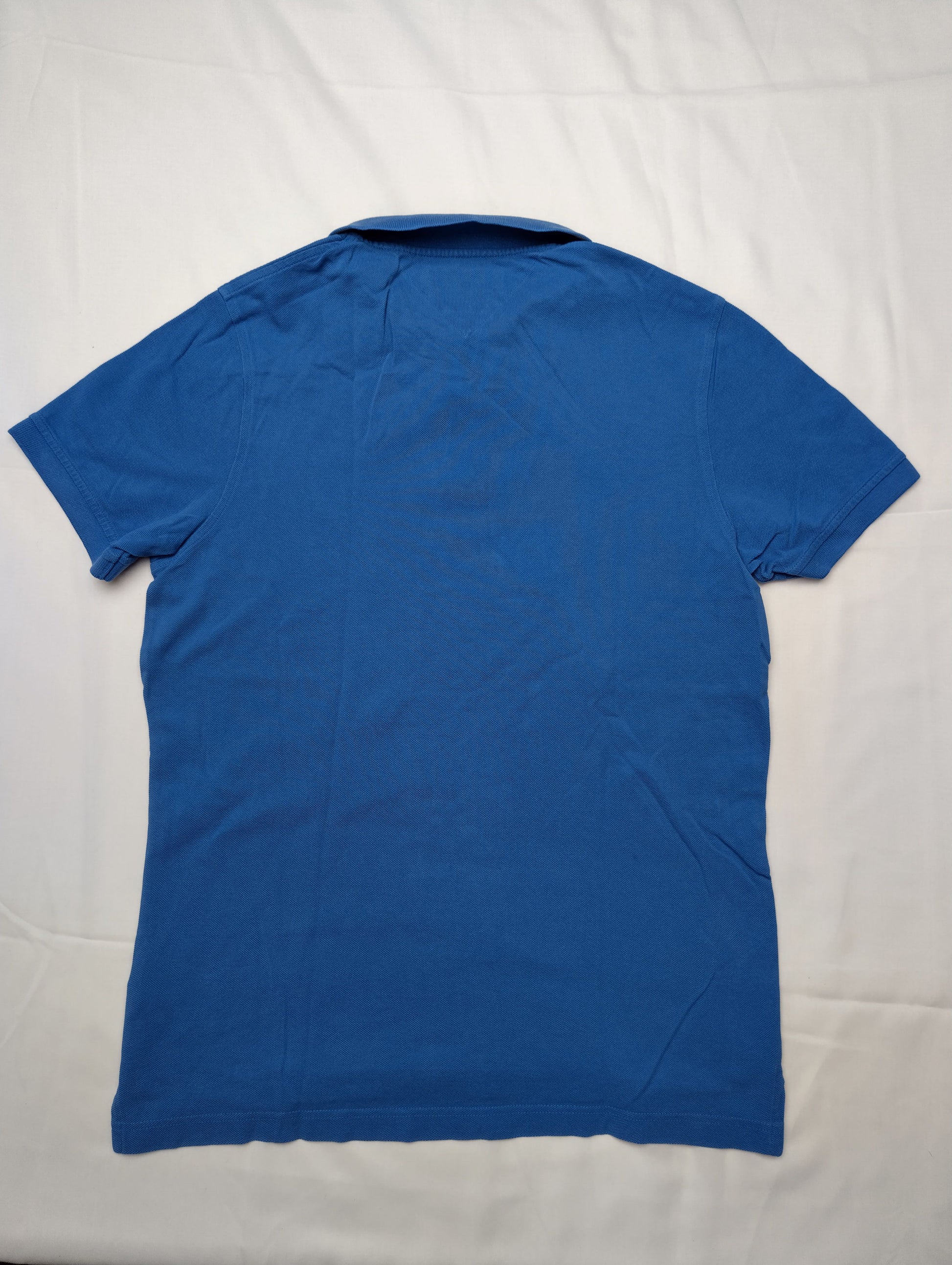 Back view of blue polo shirt