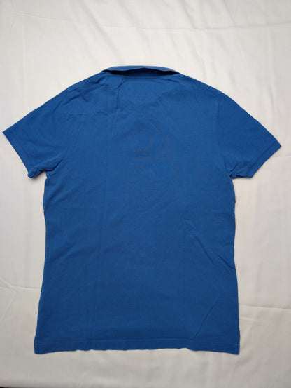 Back view of blue polo shirt