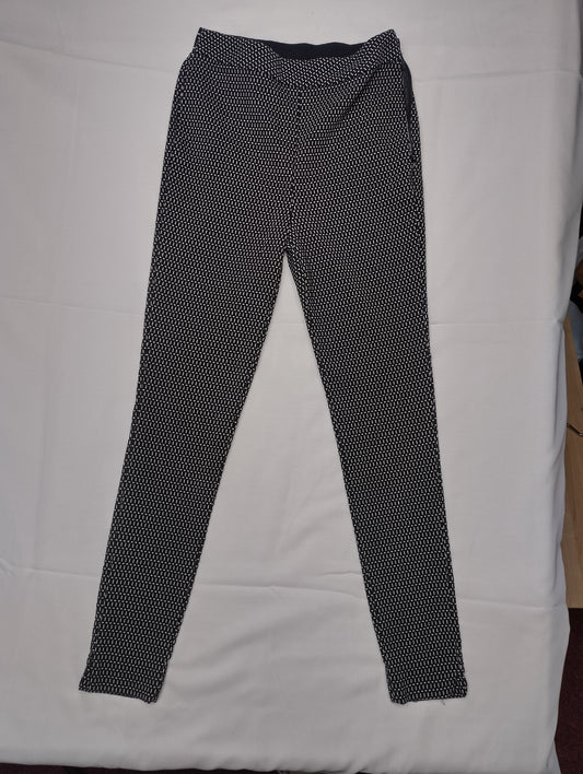 Black and white printed leggings lying flat on a surface