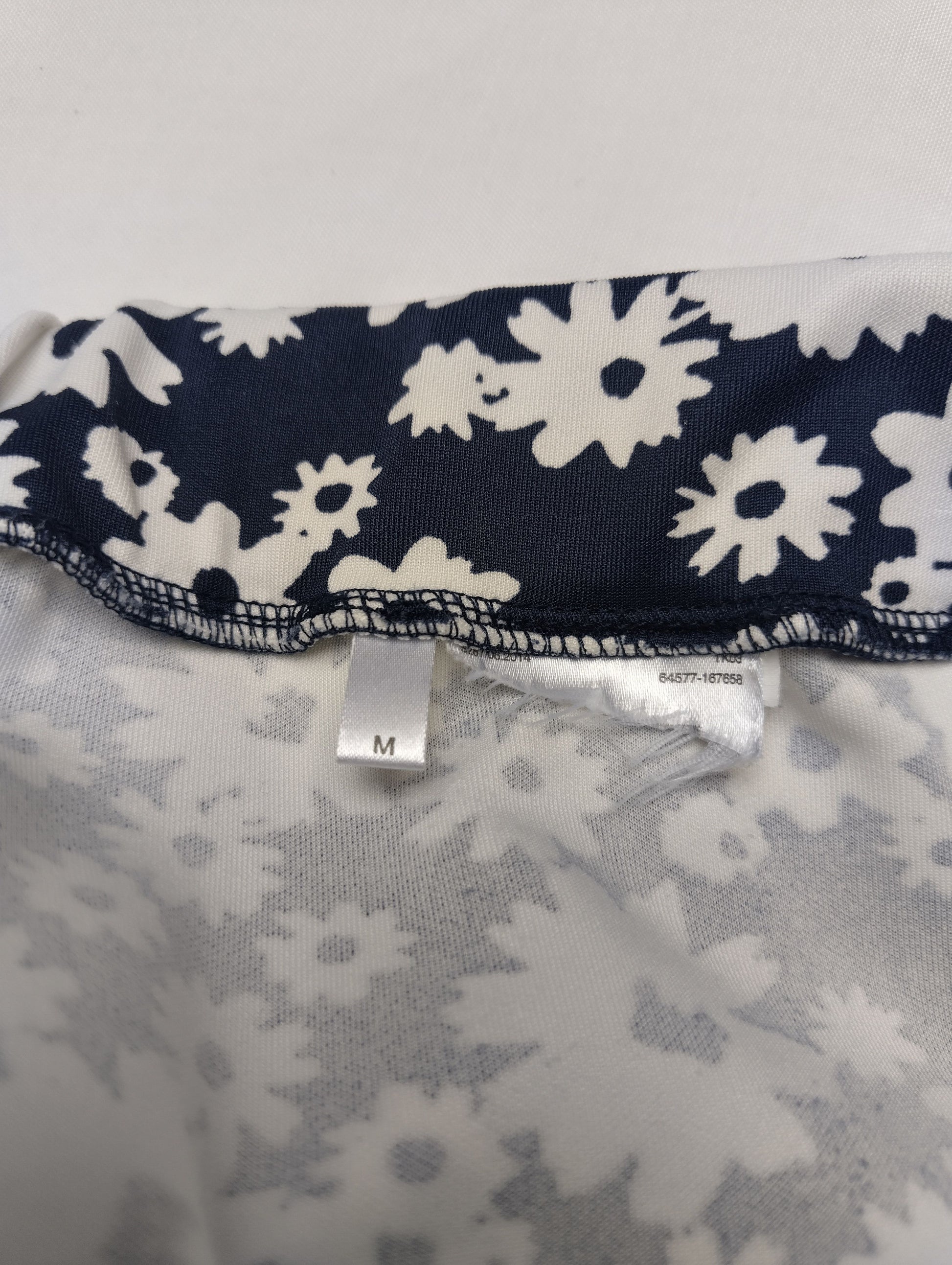 Size label M on the inside of the floral skirt