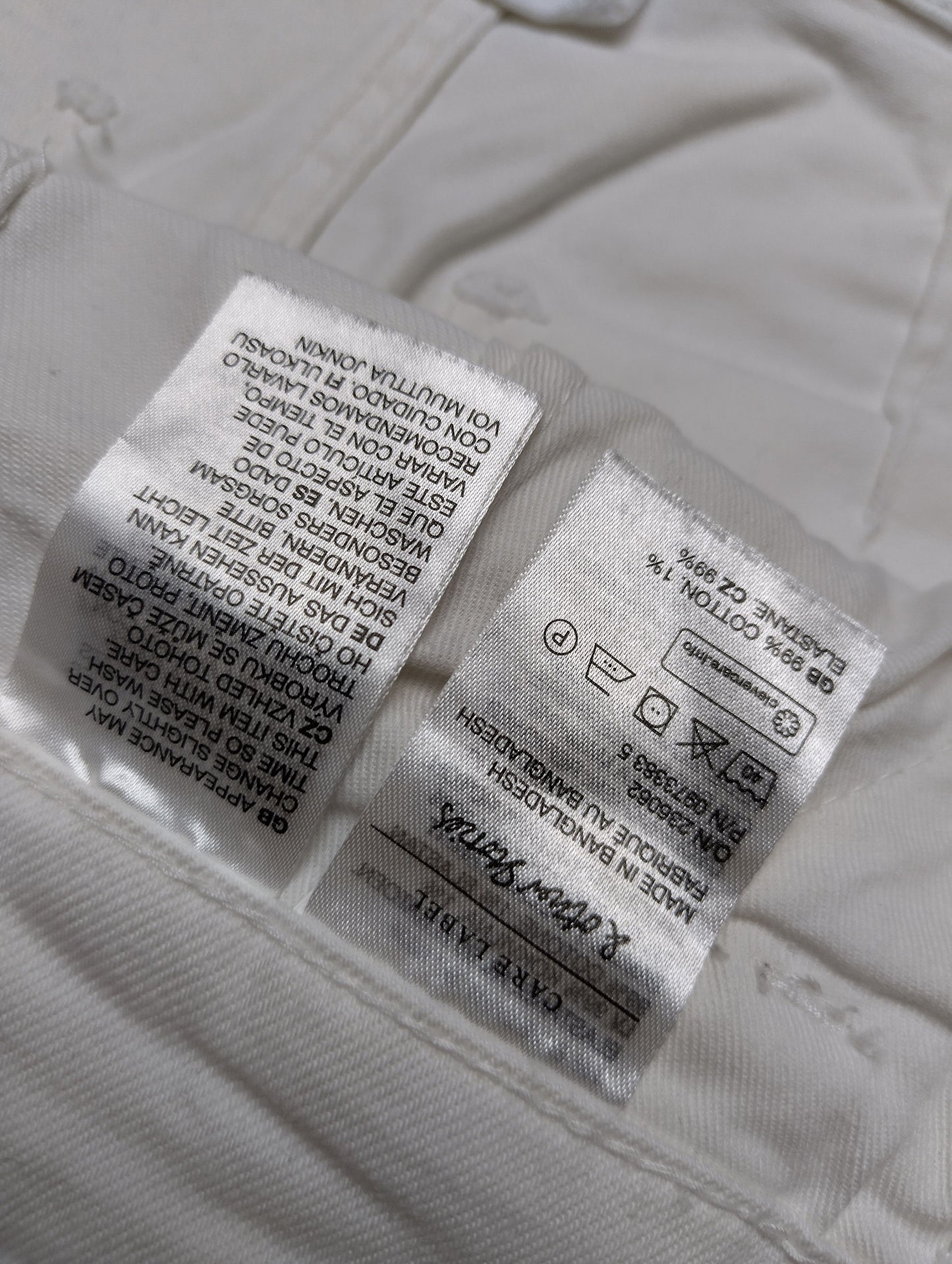 Care instructions label of white overalls