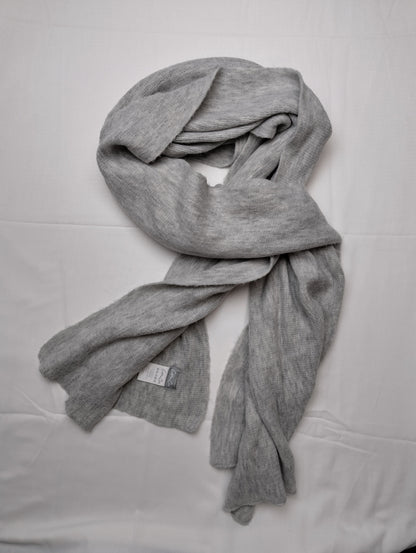 Grey scarf styled in a wrap