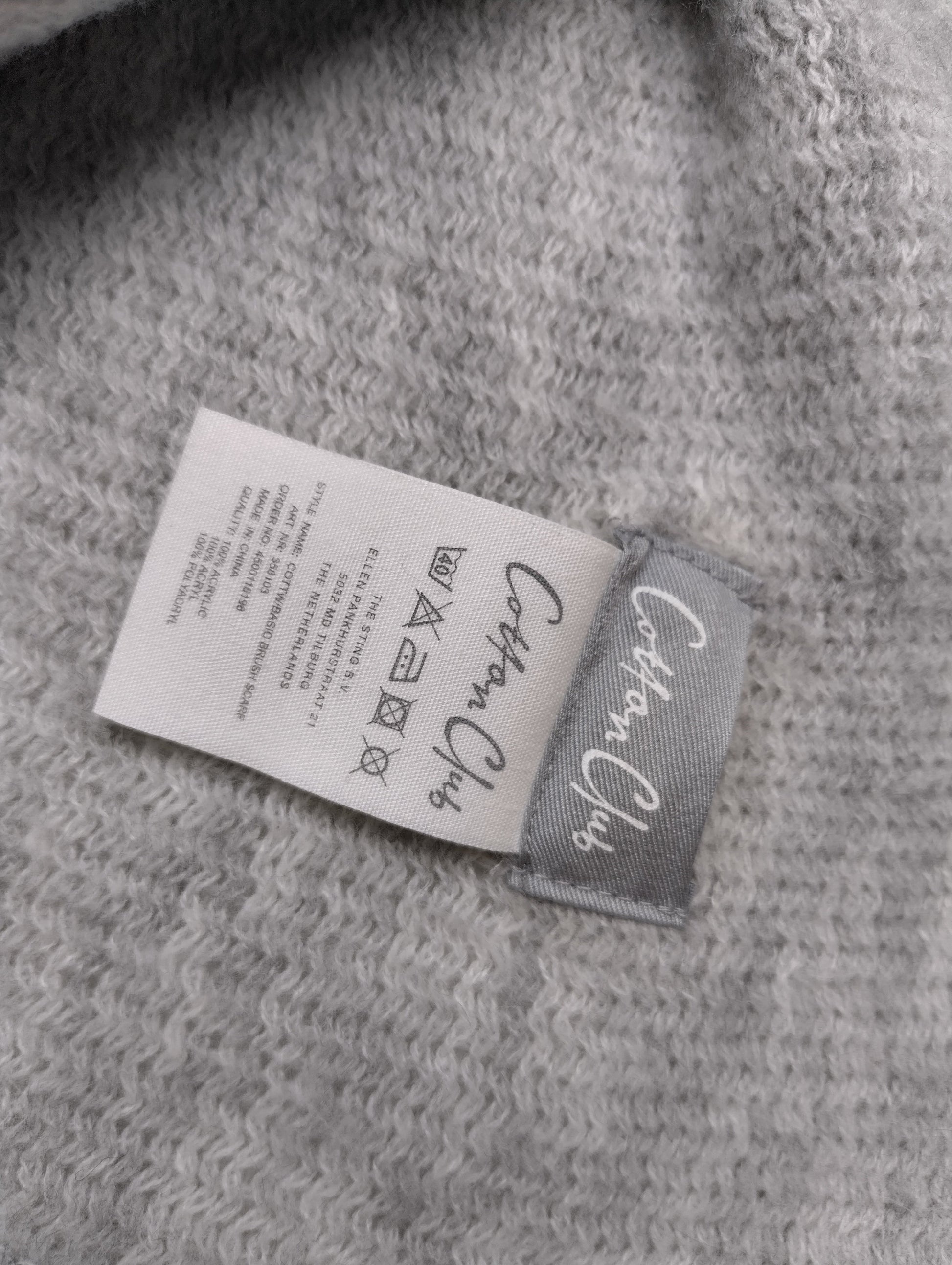Close-up of the scarf's label and care instructions