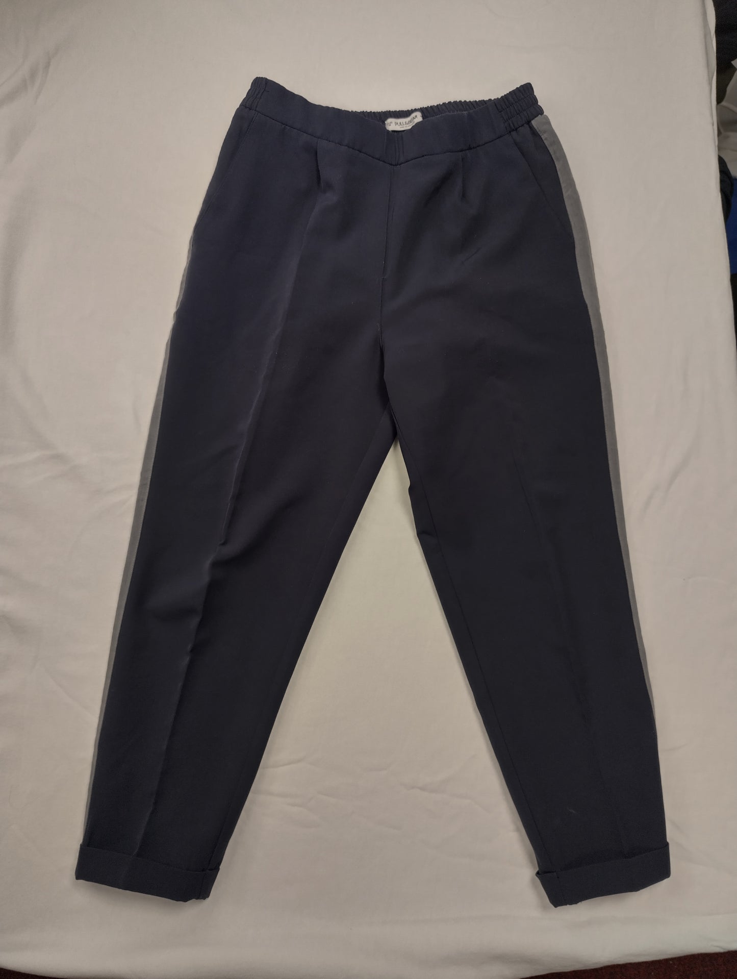Flat lay of navy pants on a white background