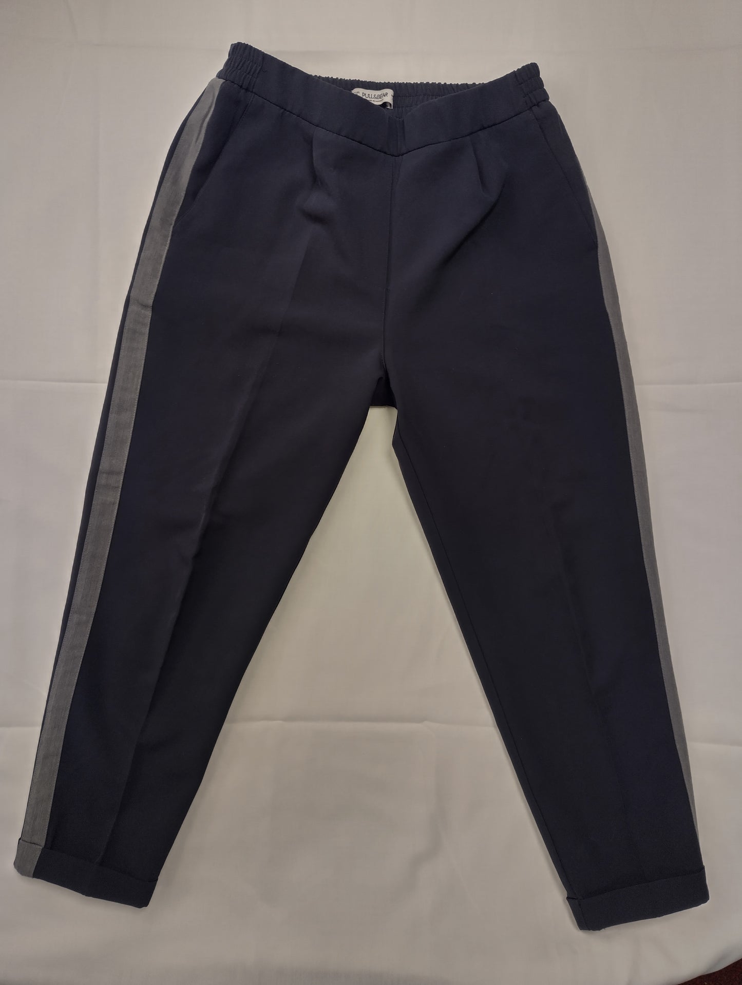 Navy pants with grey stripes, front view