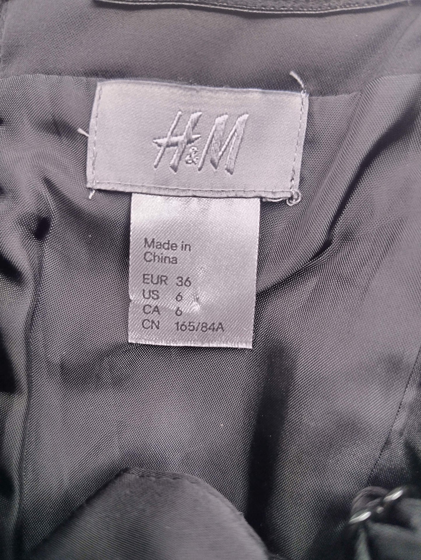 H&M size label on black dress