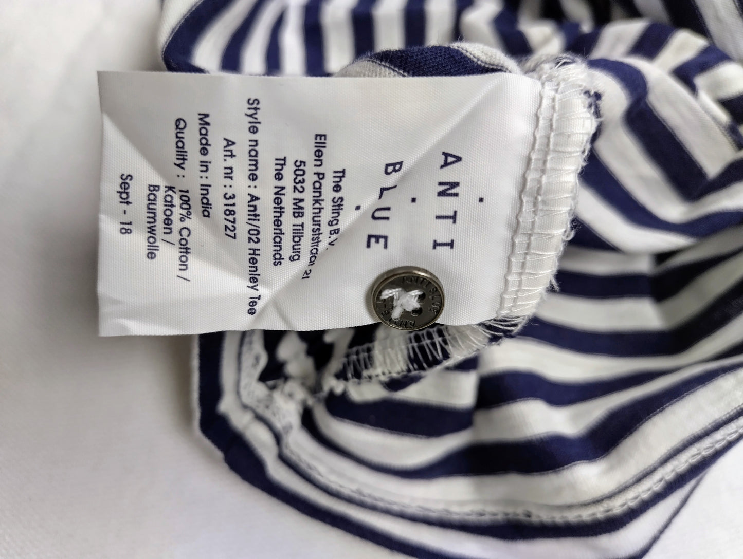 Care label of navy striped henley tee