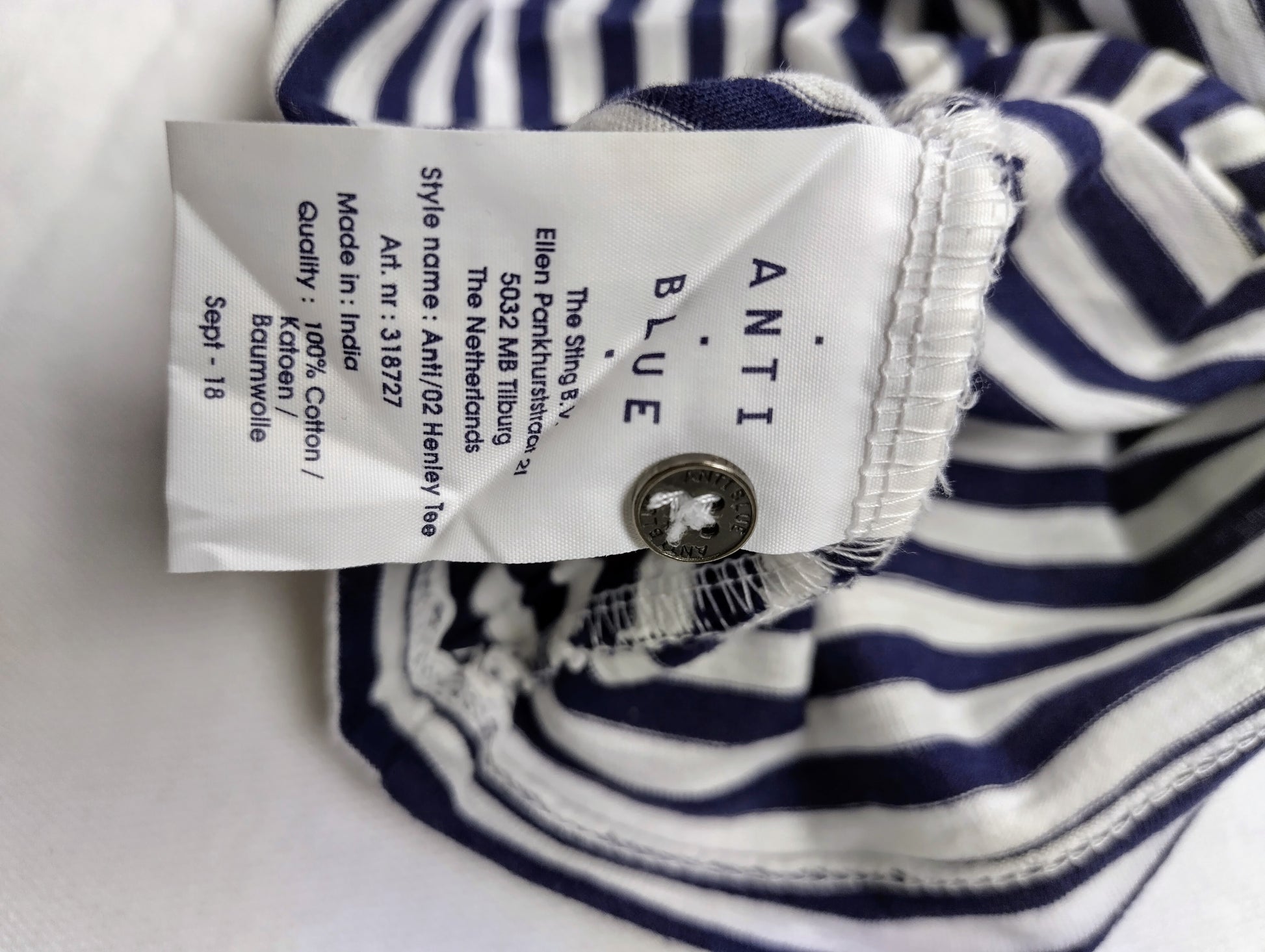 Care label of navy striped henley tee
