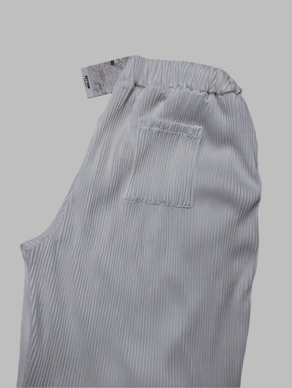 Close-up of the waistband and back pocket of white pants
