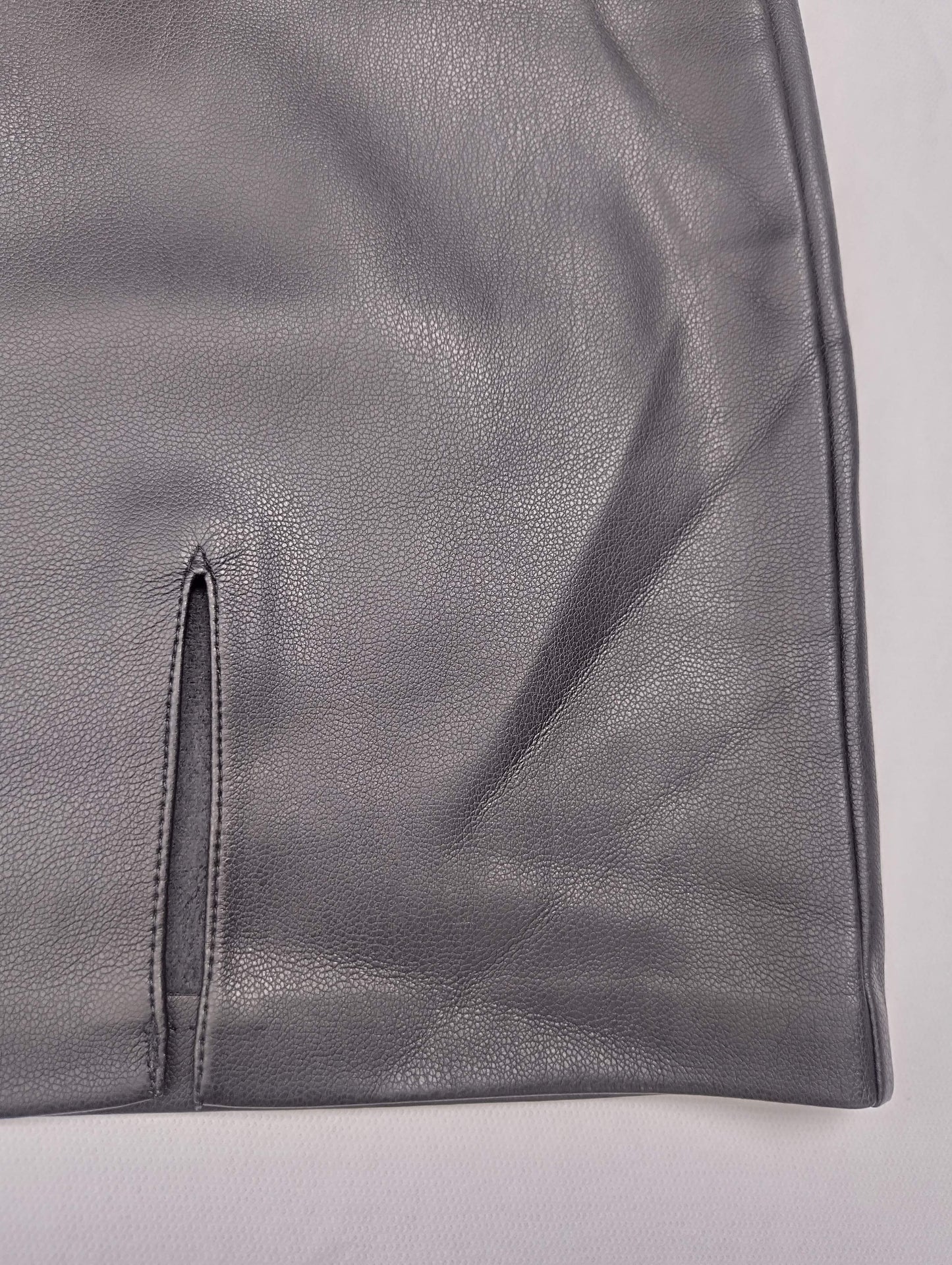 Detail of gray faux leather skirt hem