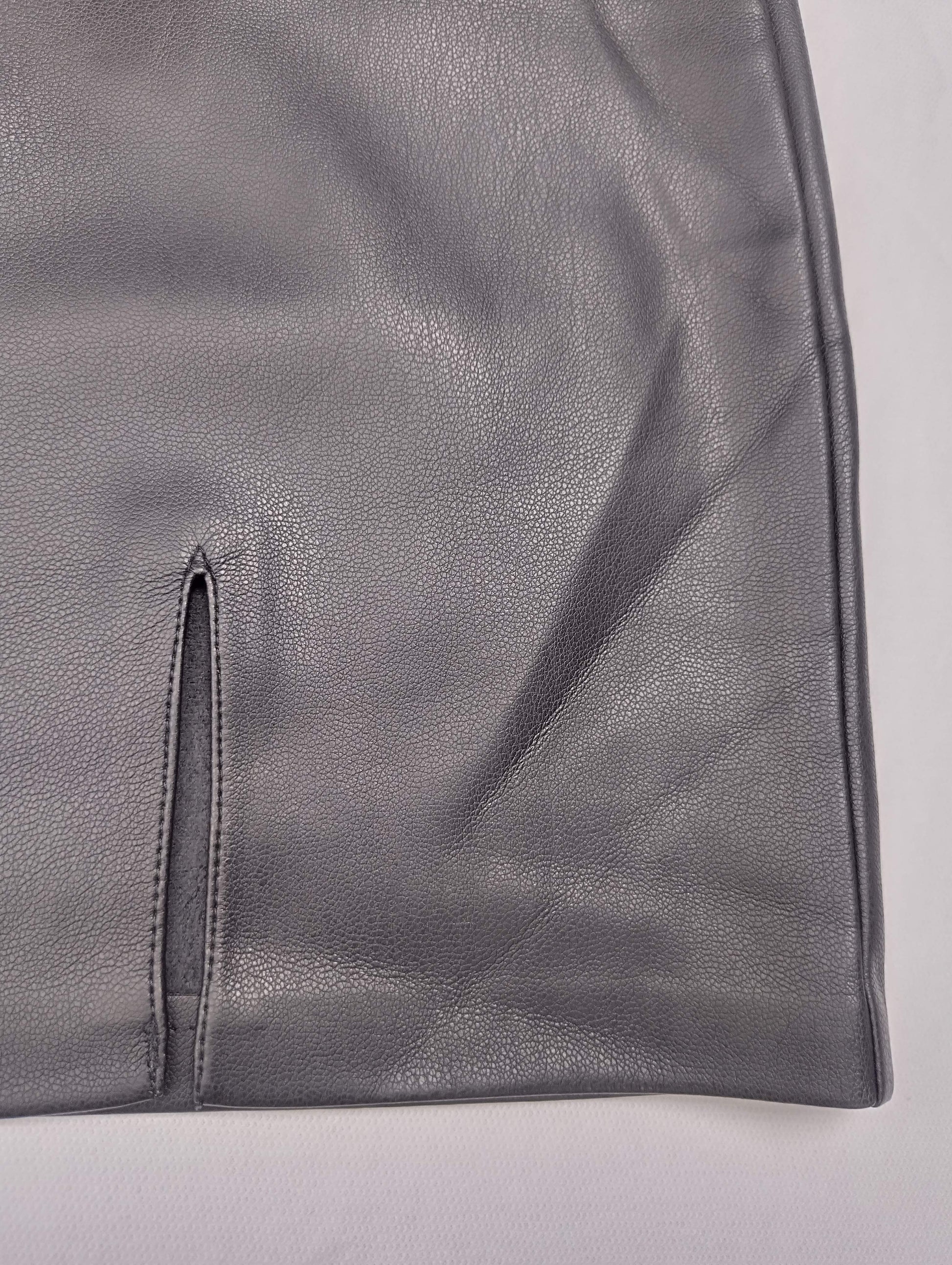 Detail of gray faux leather skirt hem