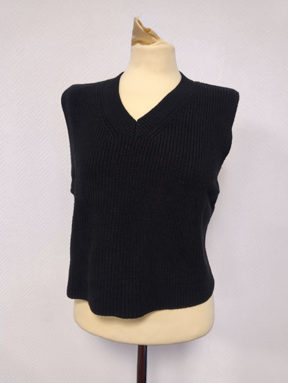 Front view of the black sleeveless knit top
