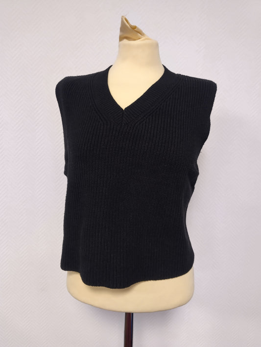 Front view of the black sleeveless knit top