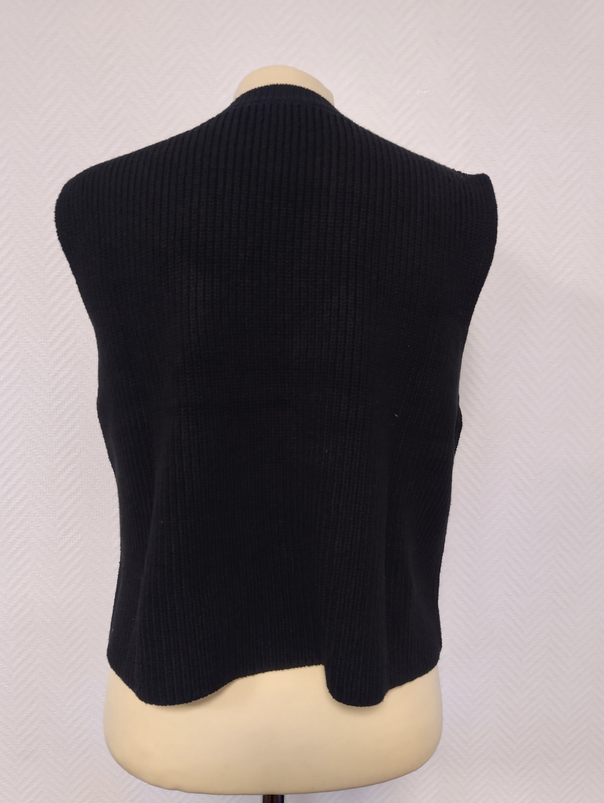 Back view of the black sleeveless knit top