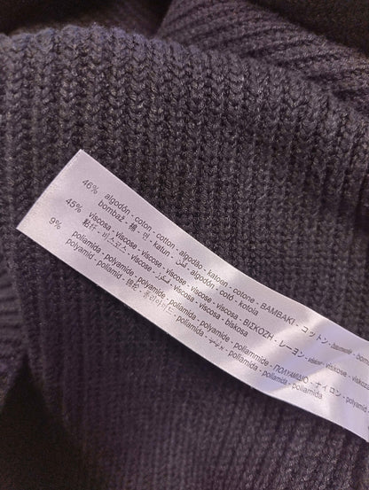 Close-up showing fabric composition of the knit top
