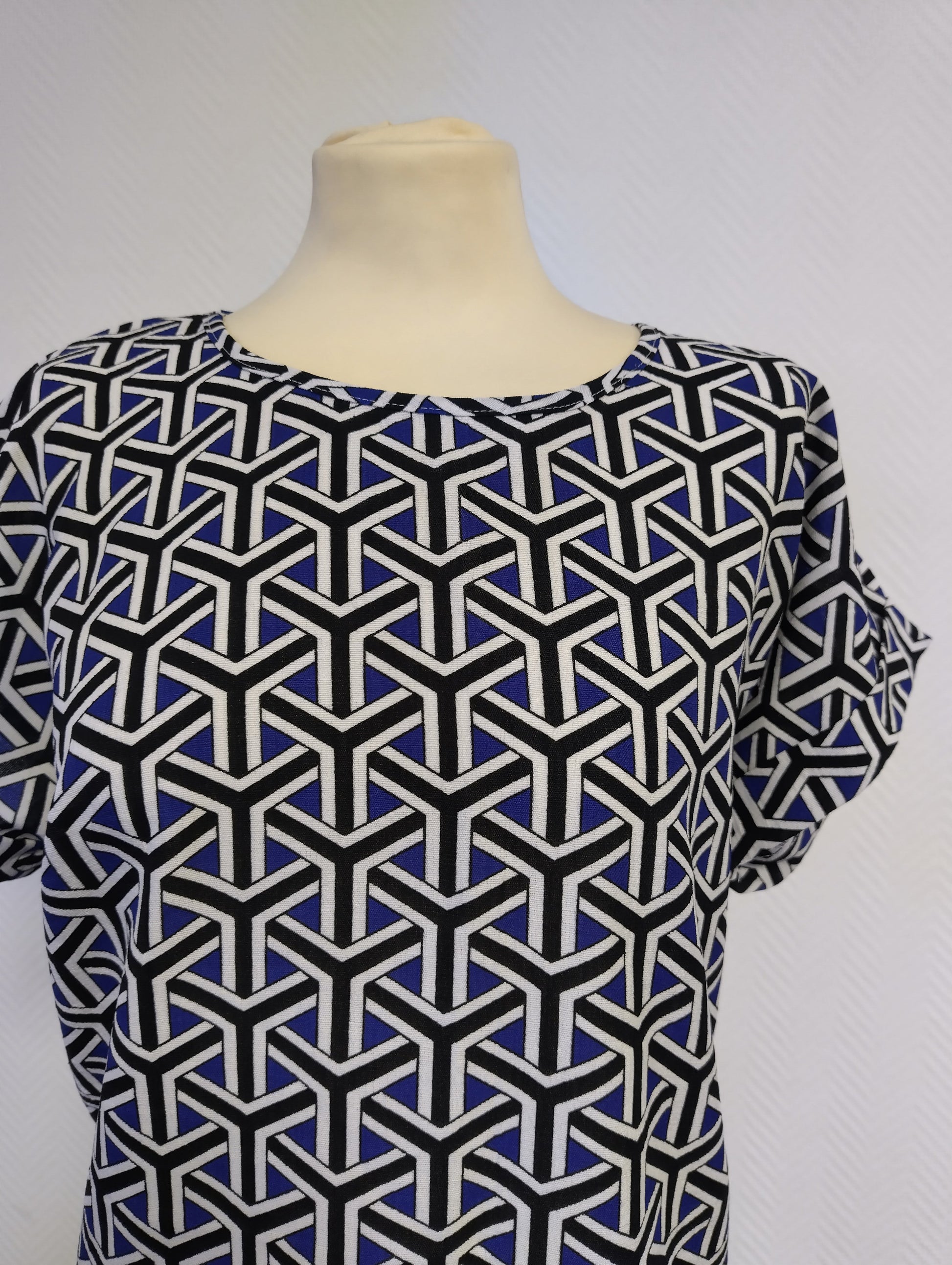 Close-up of the dress's neckline and fabric pattern