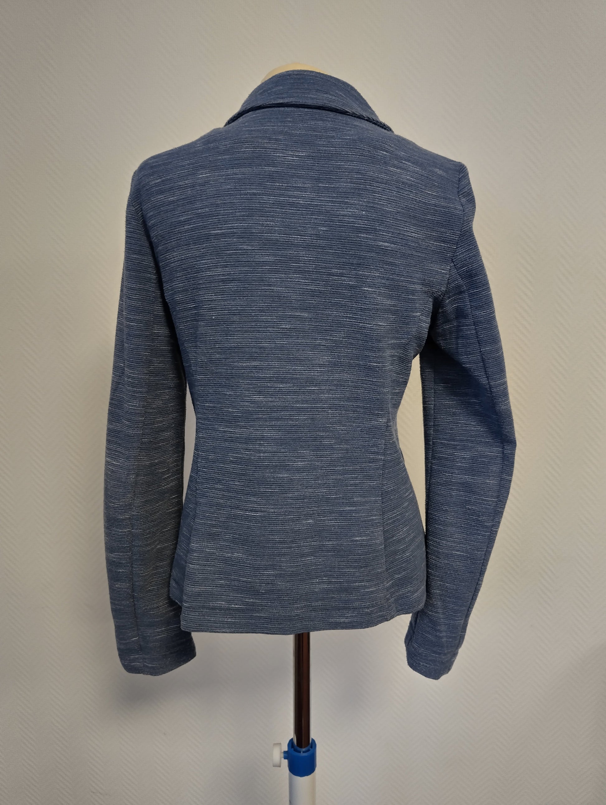 Back view of a blue blazer on mannequin