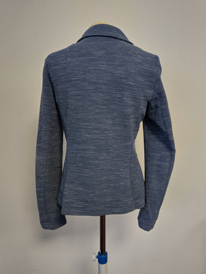 Back view of a blue blazer on mannequin