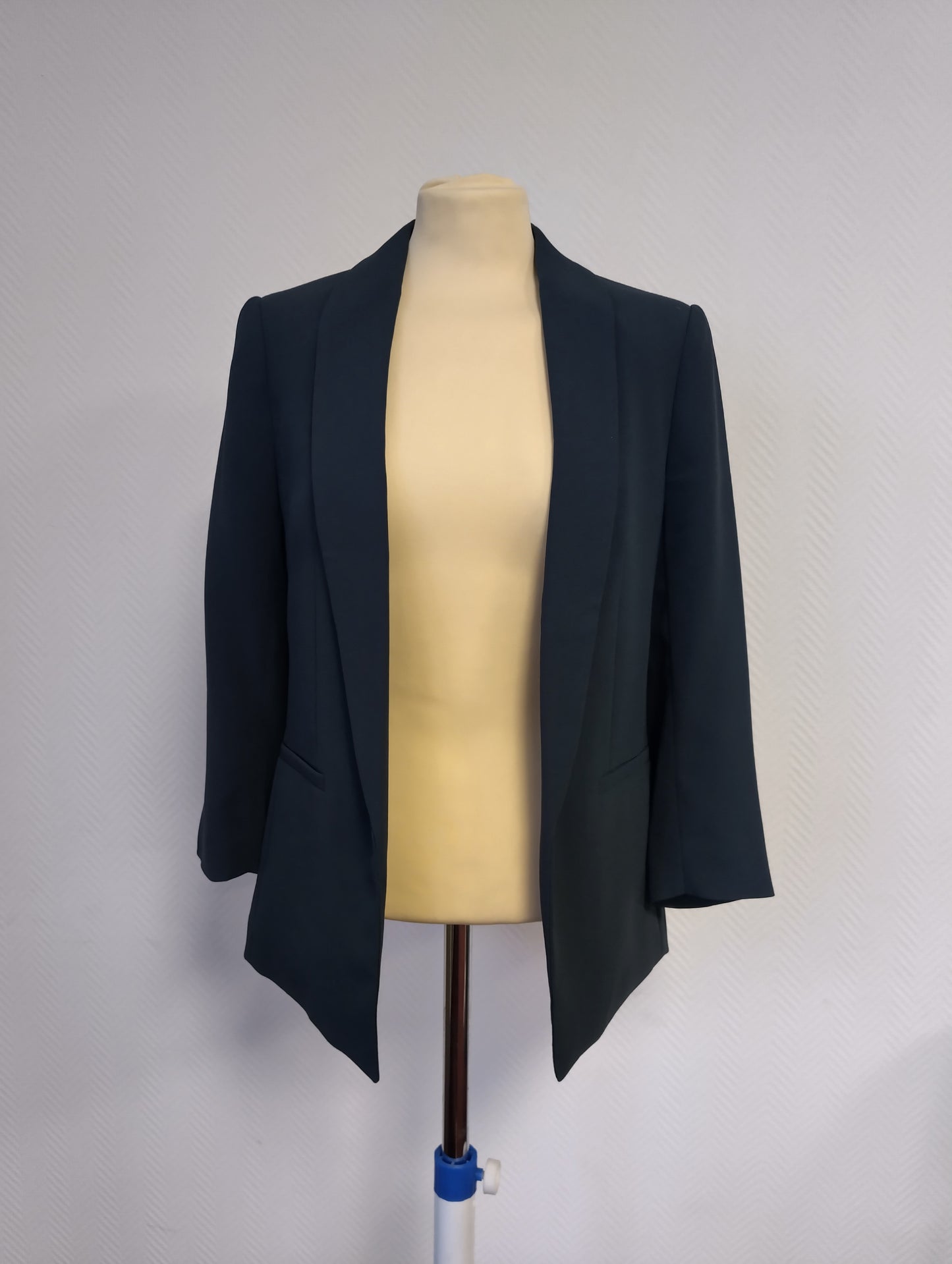 Front view of a dark navy blazer on mannequin