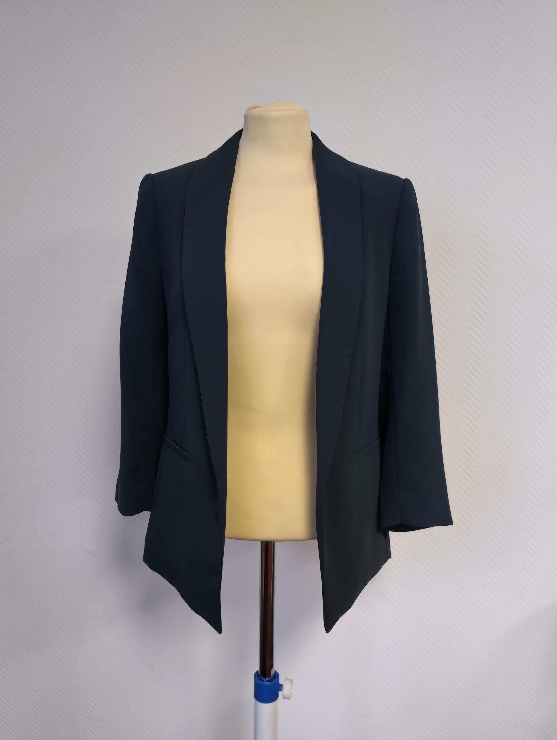 Front view of a dark navy blazer on mannequin