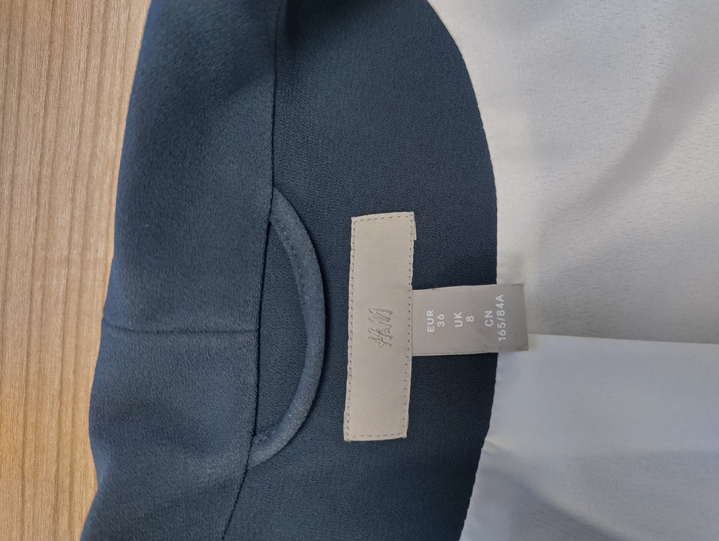 Tag of dark navy blazer showing size and brand