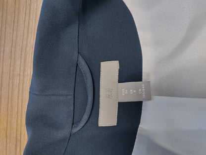 Tag of dark navy blazer showing size and brand