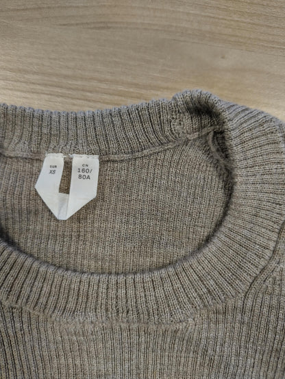 Close-up of the sweater's label showing size XS