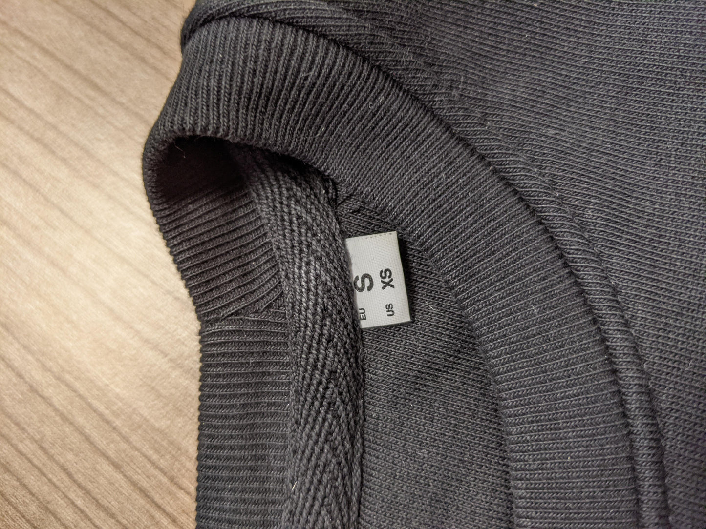 Close-up of size label on sweatshirt