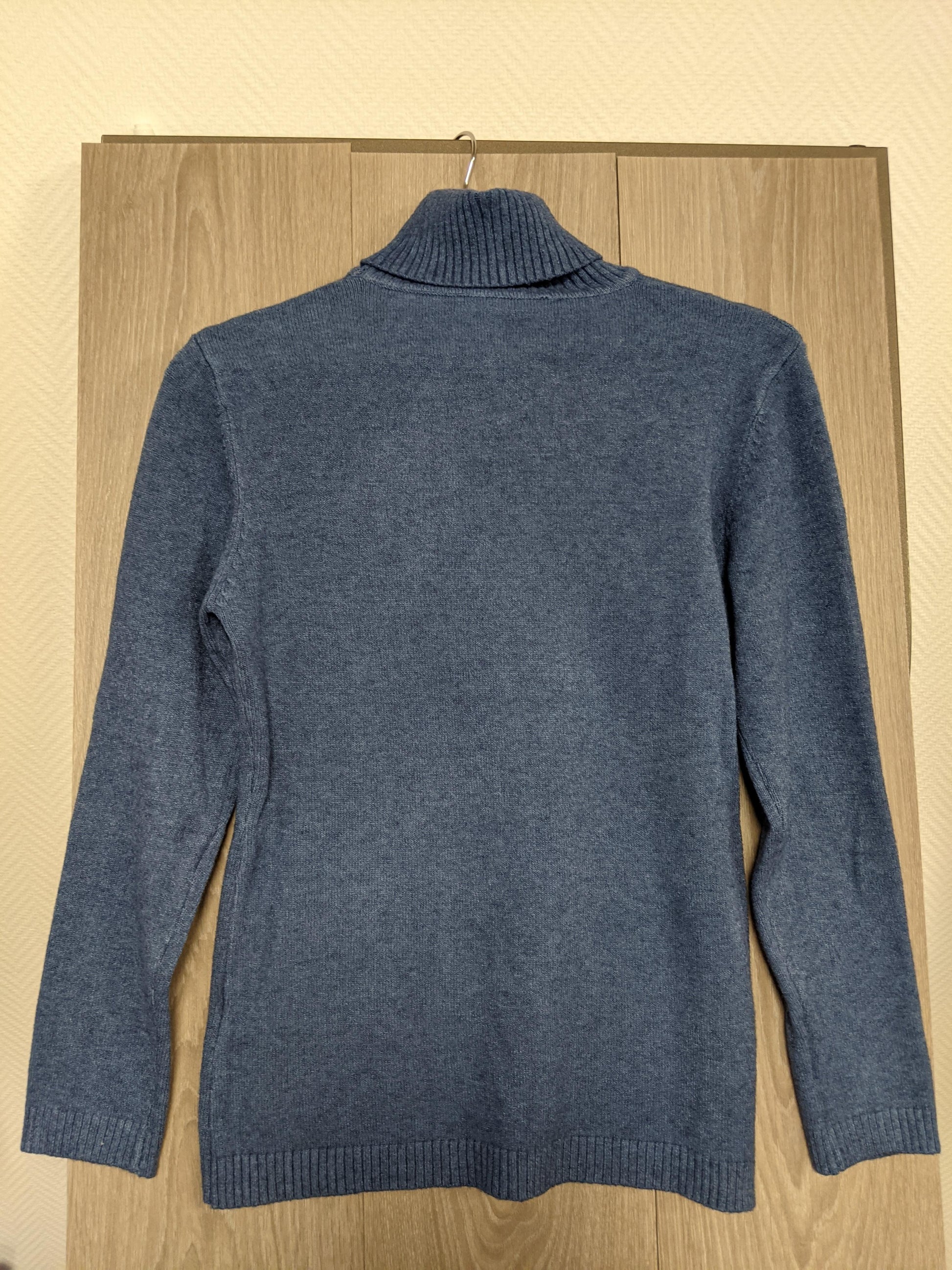 Close-up of the blue turtleneck sweater's collar