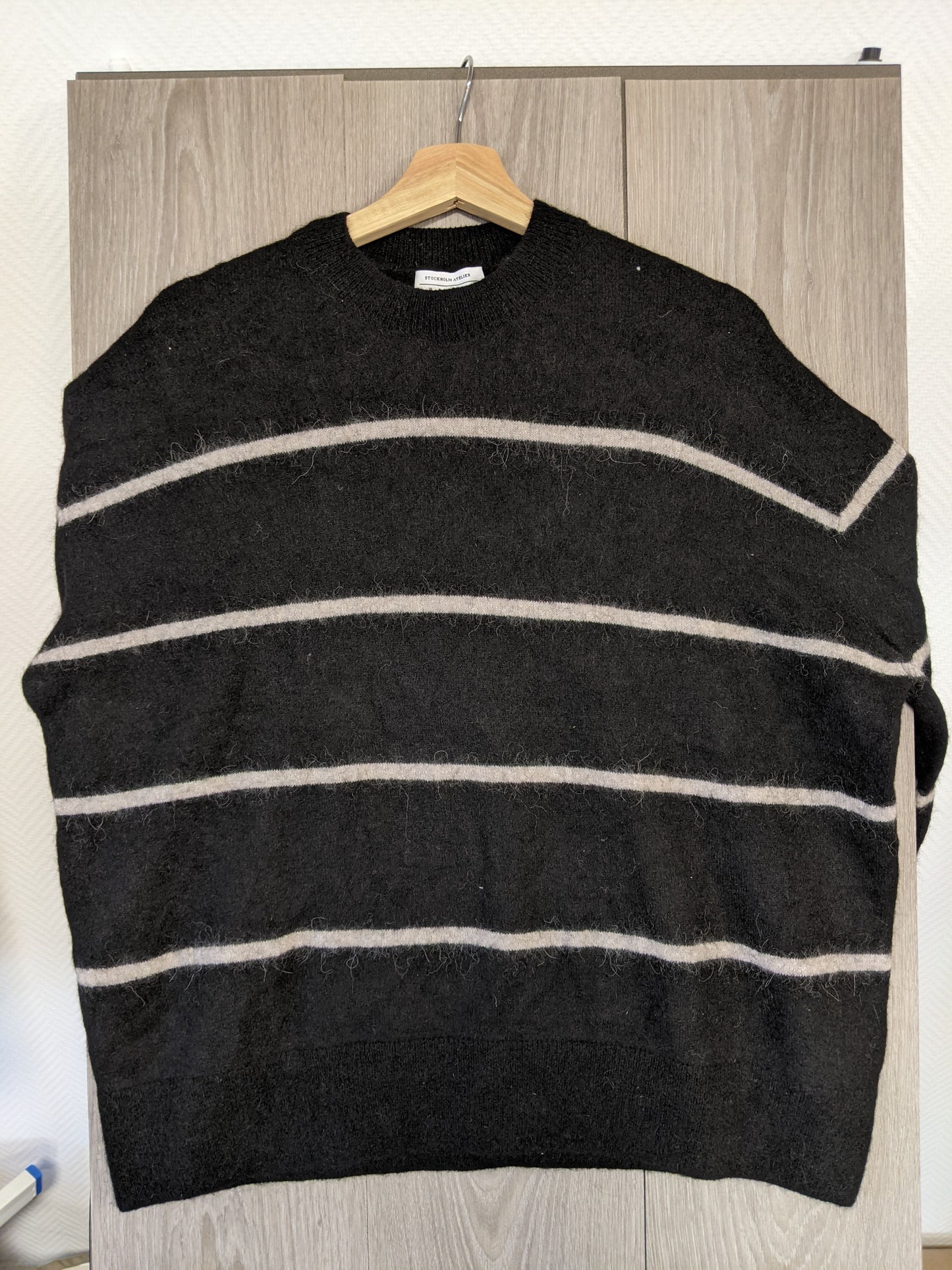 Front view of a black striped sweater