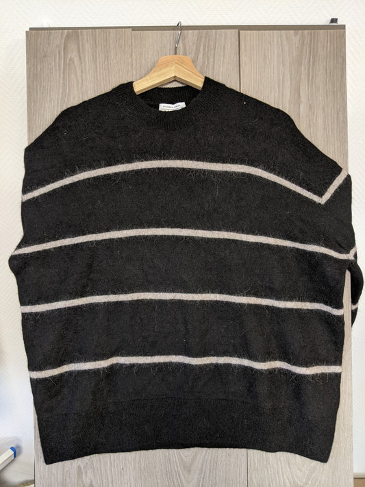 Front view of a black striped sweater