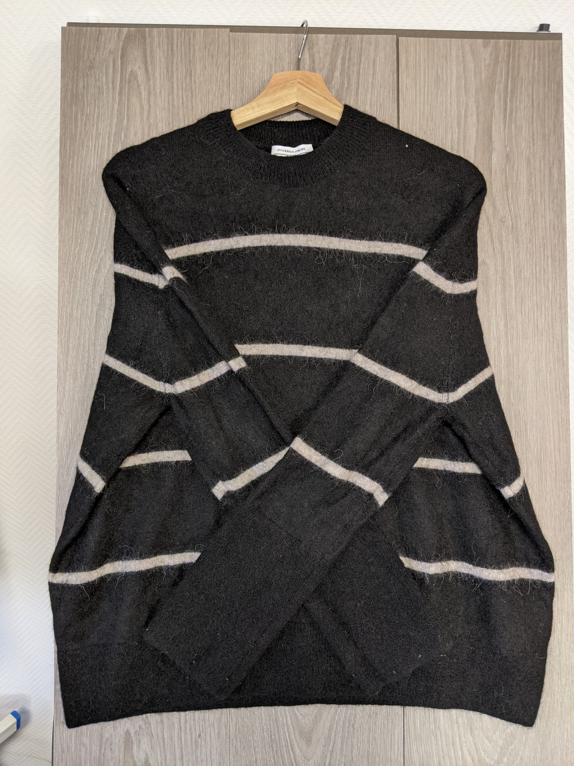 Side view of a black striped sweater