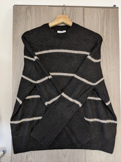 Side view of a black striped sweater