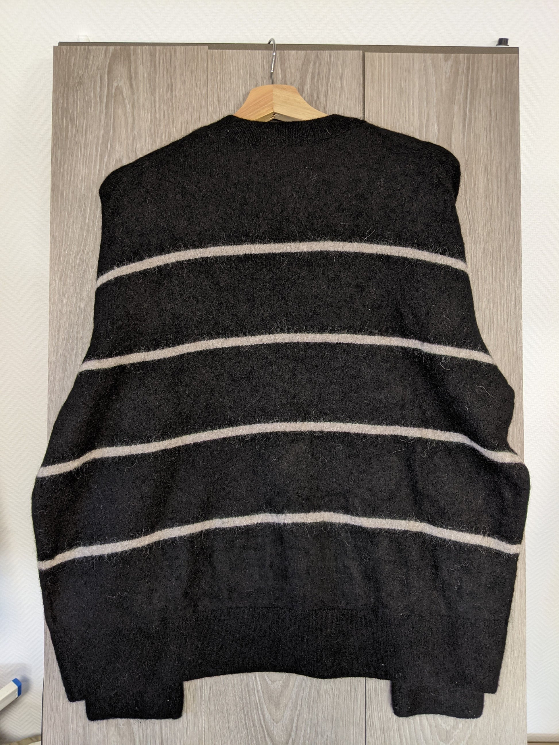 Back view of a black striped sweater