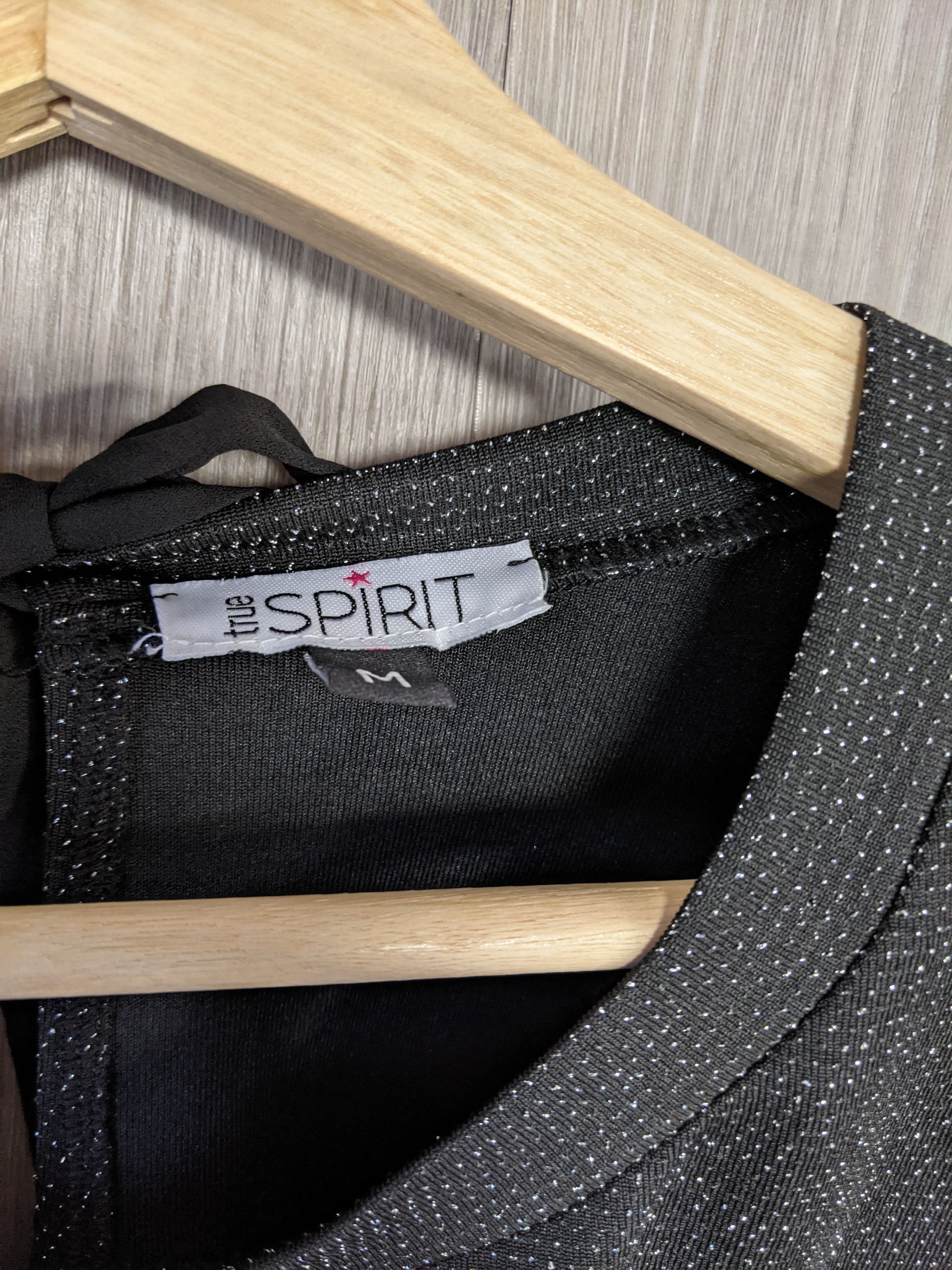 Close-up of the label on the sparkly black top