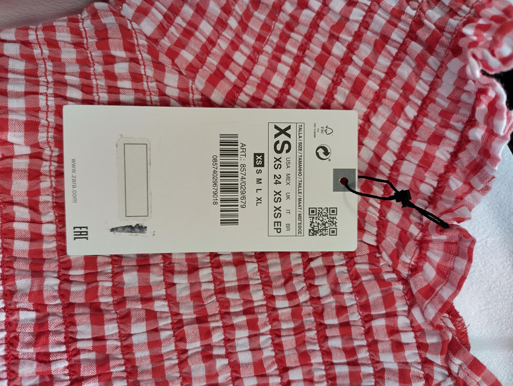 Close-up of red gingham crop top tag