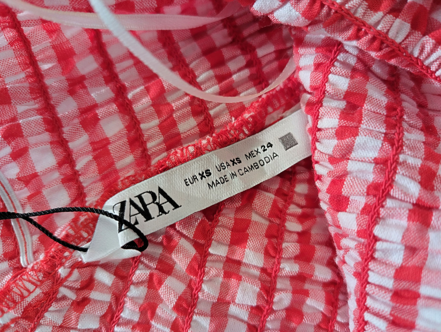 Label on red gingham crop top