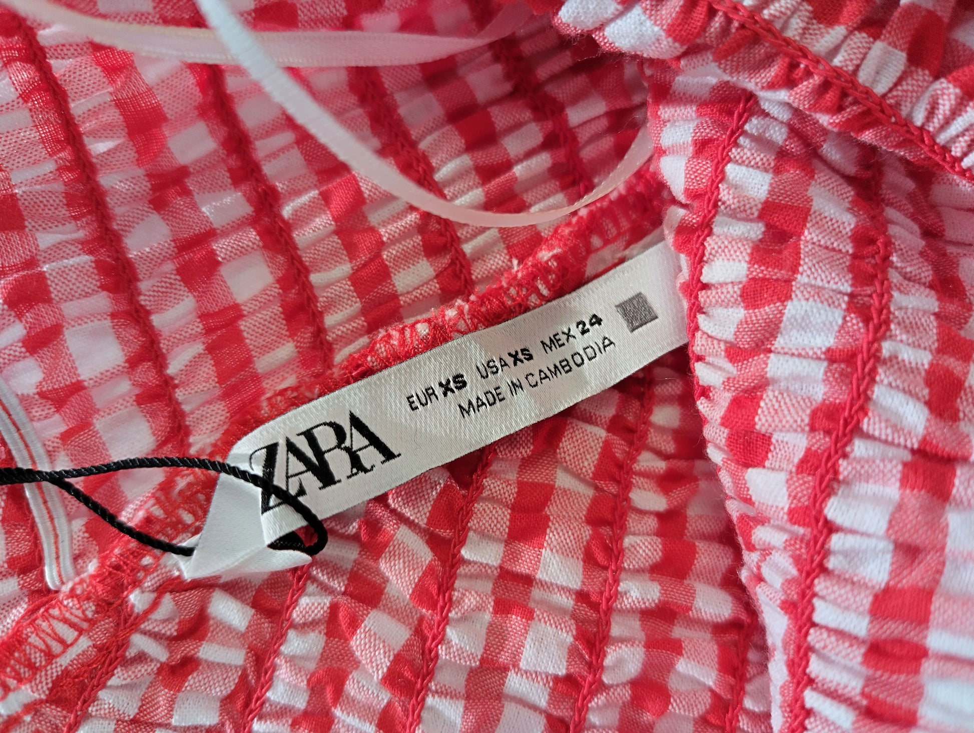 Label on red gingham crop top