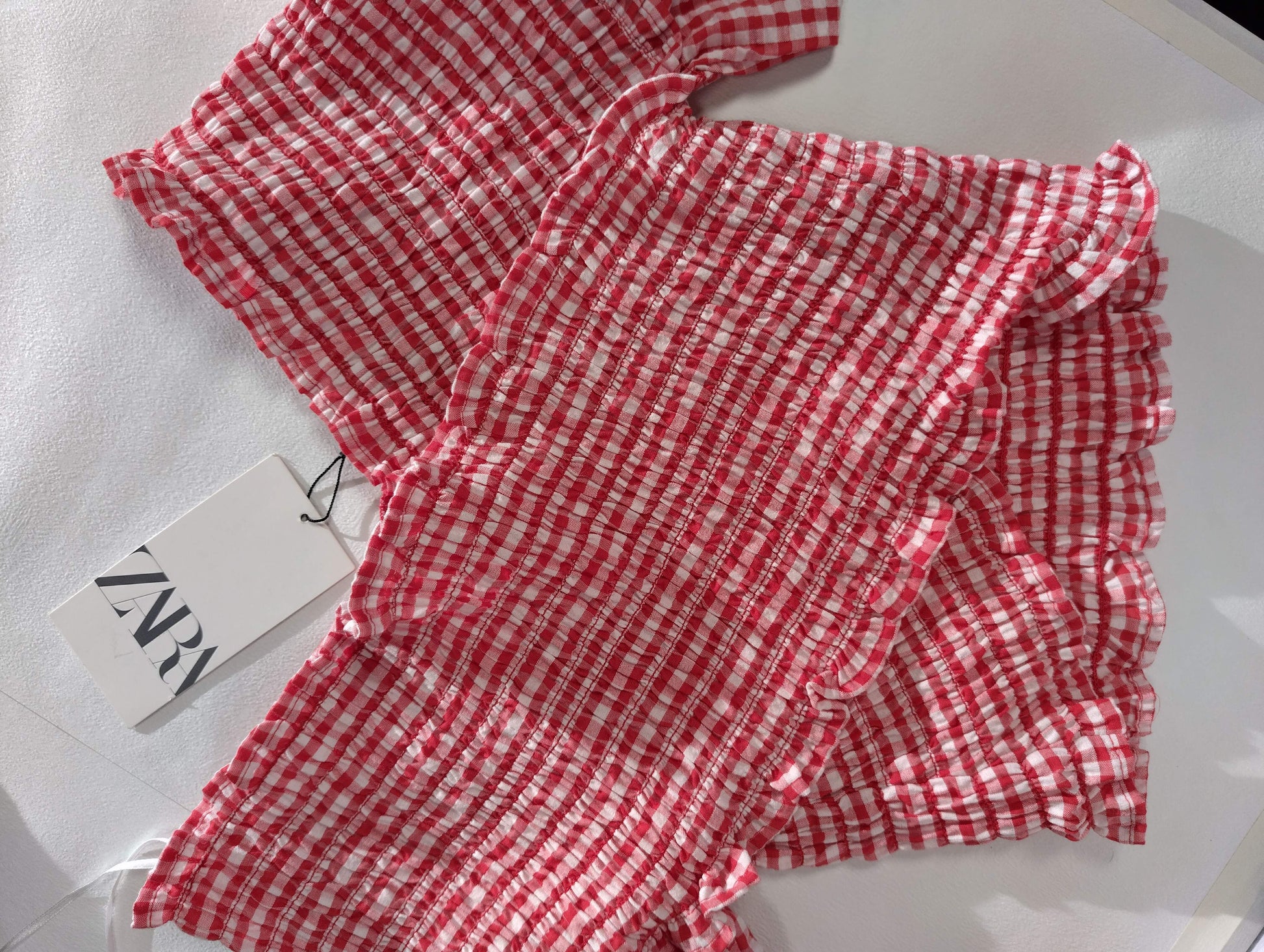 Red gingham fabric details with tag