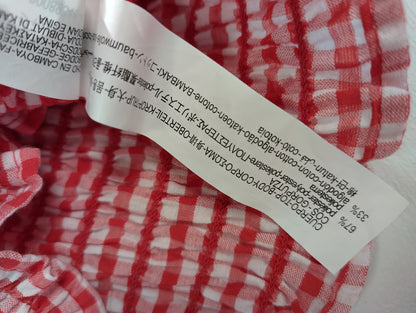 Washing instructions label on red gingham top